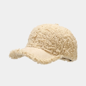 Detailed close-up of beige fleece baseball cap showing soft lambswool texture and stitching