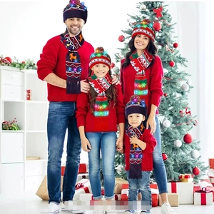 Detail of LED knit Christmas hat and scarf set with glowing reindeer and snowflake patterns