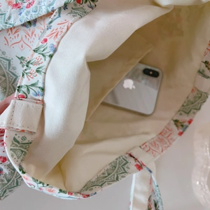 Macro view of canvas tote bag interior showing reinforced stitching and handy inner pocket
