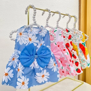 Detail of pet summer dresses with floral prints and bow knots on pearl hangers