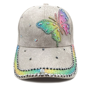 Close-up of baseball cap with rainbow sequin butterfly and silver rhinestone trim