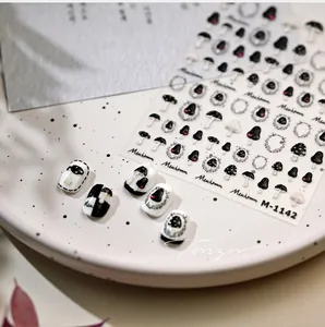 Close-up of M-1142 mushroom nail art stickers with red heart details on ceramic plate