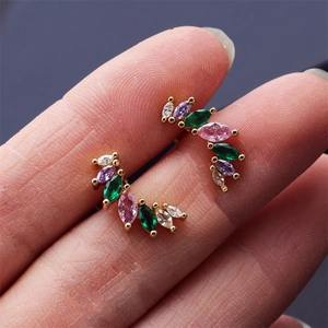 Macro shot of gold-plated stud earrings with multi-color marquise-cut crystals