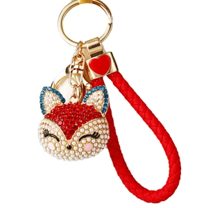 Charming fox head keychain with white pearls, red rhinestones, and woven red strap