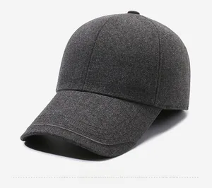 Detailed view of gray wool baseball cap with thick texture and metallic logo plate