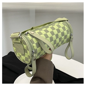 Detail of checkered barrel bag with green textured fabric and adjustable strap