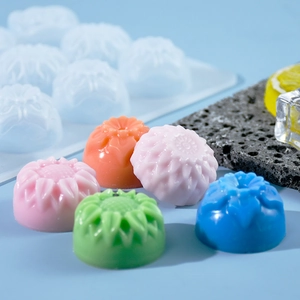 Detail of 15-cavity flower silicone mold with colorful sunflower chocolates and cakes