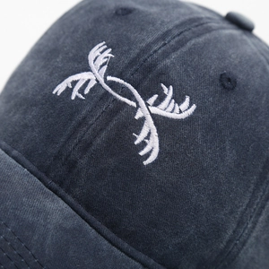 Navy blue washed baseball cap with white antler embroidery and vintage distressed finish