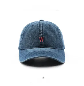 Detailed close-up of dark blue denim baseball cap with red embroidered W letter