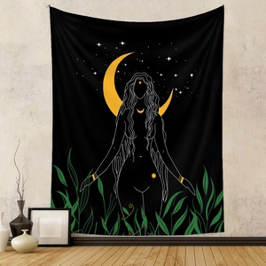 Detail of bohemian black tapestry with moon goddess silhouette on a grey textured wall