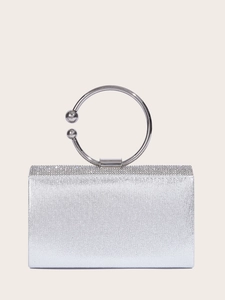 Detailed macro view of sparkling silver glitter evening clutch with rhinestone trim and ring handle