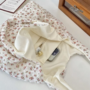 Detailed view of the large capacity interior with zipper pocket in a floral tote bag