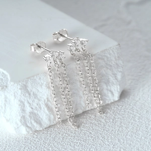 Detail showing the s925 sterling silver chain tassel earrings with sparkling zircon