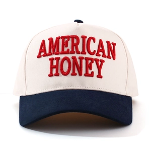 Close-up of American Honey red embroidery on off-white and navy blue baseball cap