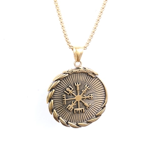 Macro view of Nordic Vegvisir compass pendant in antique gold finish on box chain