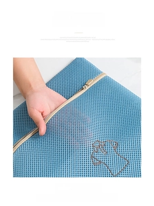 Detail of blue honeycomb laundry bag with durable mesh fabric and shirt embroidery
