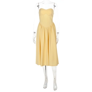 Detail view of the yellow strapless dress showing the boned corset waist and long skirt