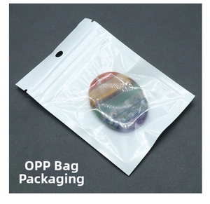 Polished oval seven chakra stone with colorful layers in transparent OPP bag packaging