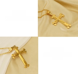 Detail view of multi-layered 18k gold plated titanium steel cross pendant necklace