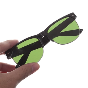 Retro black Wellington sunglasses with vibrant green lenses and silver metal rivets