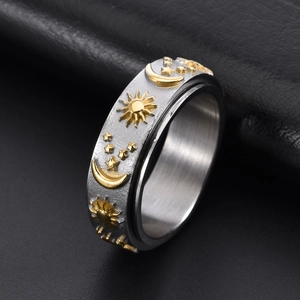Two-tone stainless steel spinning ring with gold sun moon star motifs on black leather