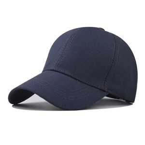 Close-up of navy blue cotton baseball cap showing reinforced brim stitching and texture
