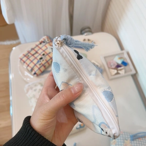 Close-up of a blue cotton mini pouch with cute bear prints and a zipper tassel detail