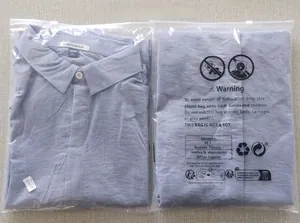 Detailed view of folded light blue cotton linen shirt in retail protective packaging