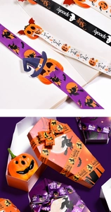 Detail of Halloween grosgrain ribbons with pumpkins and spider webs for gift wrapping