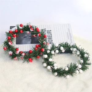 Christmas candle rings with red and white berries and snowy pine needles for home decor