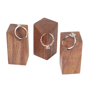 Three walnut wood cone ring stands in varied heights for creative jewelry display