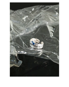 Macro shot of silver molten texture ring featuring two round blue zircon gemstones