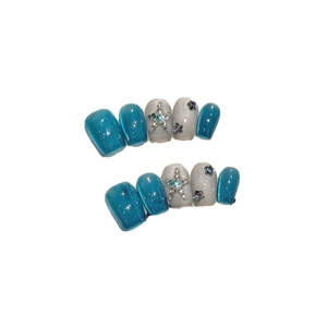 Blue cat eye press-on nails with silver glitter, 3D stars, and rhinestone accents