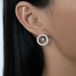 Detailed close-up of 925 sterling silver earring set with zircons on model ear