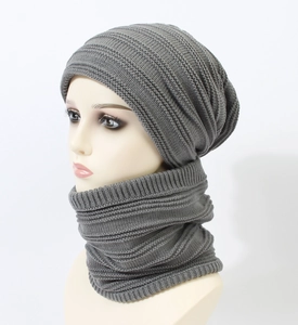 Detail of grey ribbed knit beanie and neck warmer set with thick texture on a mannequin