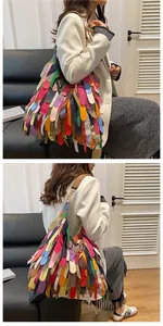 Detail of bohemian tote featuring multi-color leather fringe and brown shoulder strap