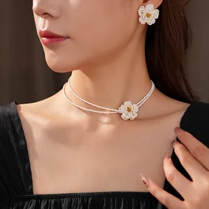 French vintage camellia pearl necklace and earring set featuring hand-woven floral pendants