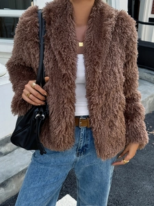 Detail shot of brown faux fur texture and long sleeves on a casual women's winter coat