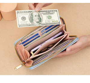 Inside view of a light blue long leather wallet showing multiple card slots and phone pocket