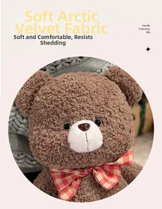 Close-up of soft brown curly teddy bear plush made of arctic velvet fabric with a bow