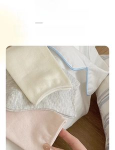 Close-up of minimalist cotton socks in beige, grey and pink with seamless elastic cuffs