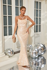 Close-up of sparkling champagne sequins and elegant mermaid hemline on party dress