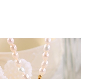 Detailed view of baroque pearl necklace with irregular shapes and golden metallic clasp