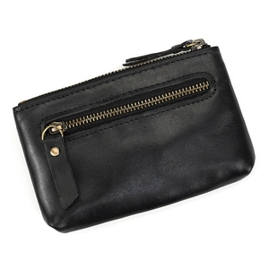 Macro view of genuine black leather texture and vintage brass zippers on the coin purse