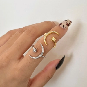 Detail of adjustable star and moon rings in silver and gold with pavé cubic zirconia
