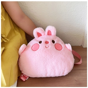 Detail of pink plush bunny backpack featuring soft long-fur fabric and embroidered face