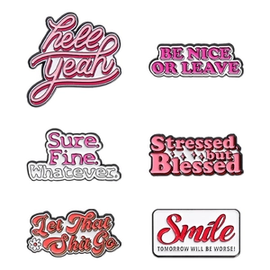 Set of six pink enamel pins with motivational quotes and pop art style typography