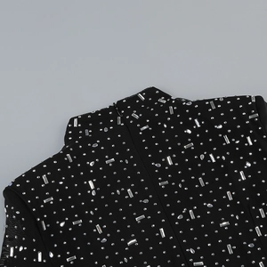 Detail of black mesh neckline featuring shimmering rhinestones and gemstone embellishments