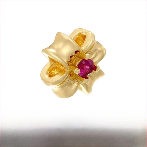 Detail of 18K gold-plated brass flower spacer bead with a red zircon center inlay