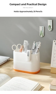 Detail of white striped desk organizer with orange base for pens and office supplies